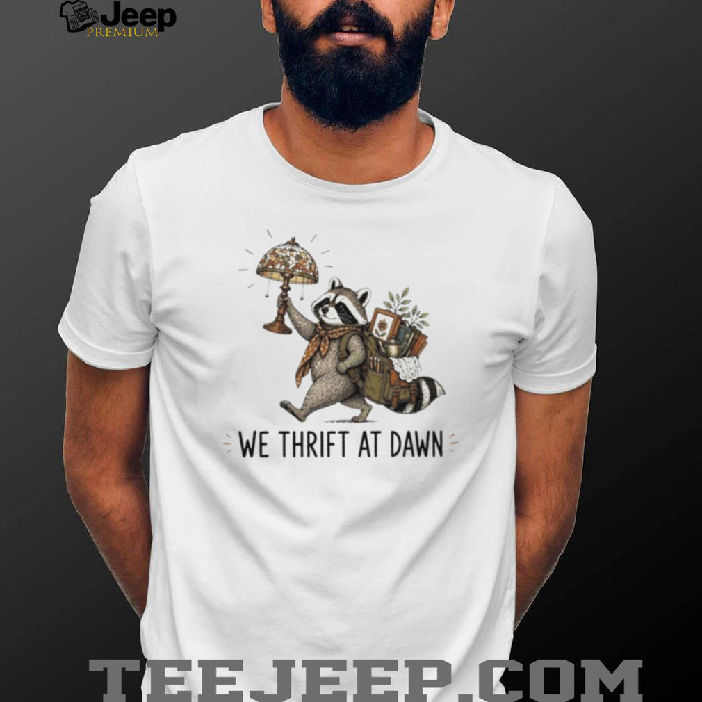 Raccoon carrying lamp and backpack items We Thrift at Dawn t shirt