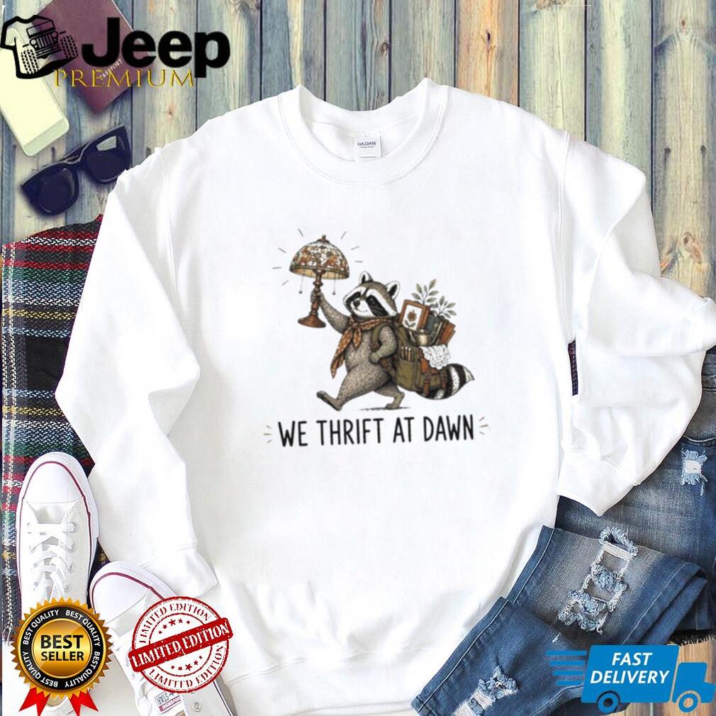 Raccoon carrying lamp and backpack items We Thrift at Dawn t shirt