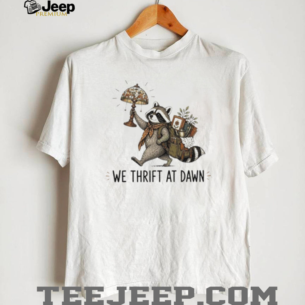 Raccoon carrying lamp and backpack items We Thrift at Dawn t shirt