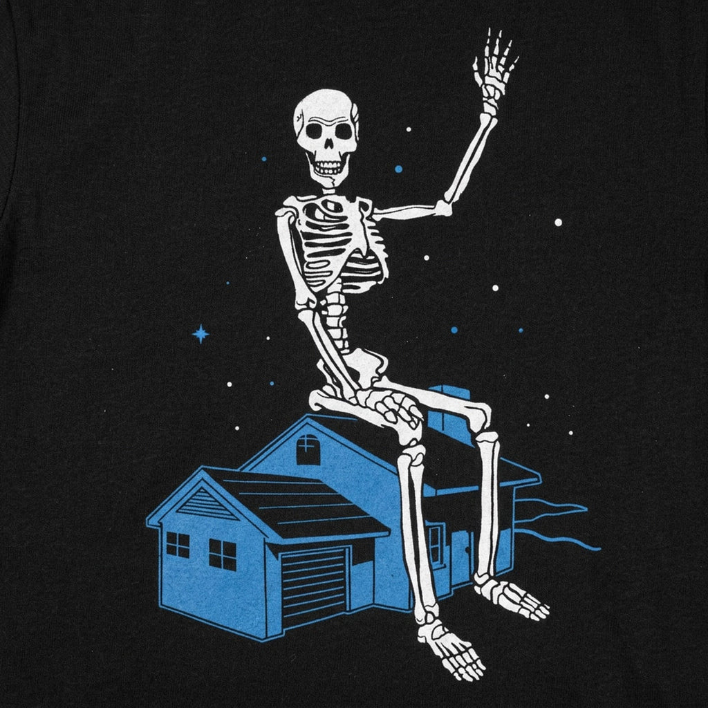 Giant Skeleton Waving from Rooftop of a House