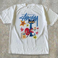 Stussy Pete the Cat tee with cat playing red guitar with stars and amp graphic