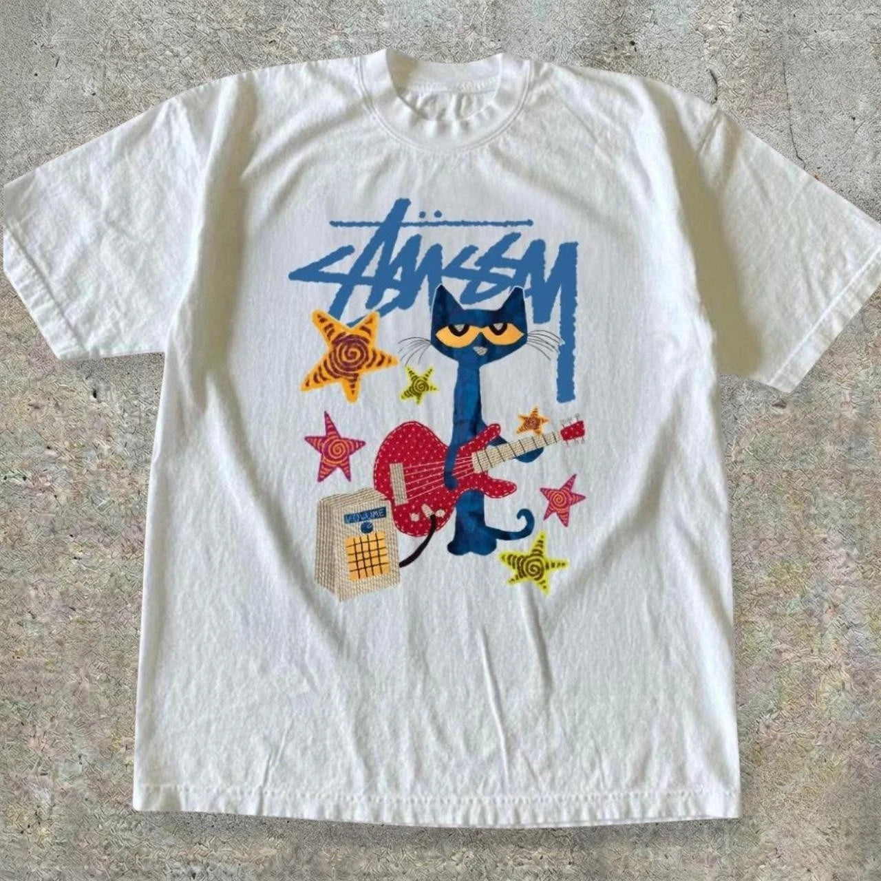 Stussy Pete the Cat tee with cat playing red guitar with stars and amp graphic